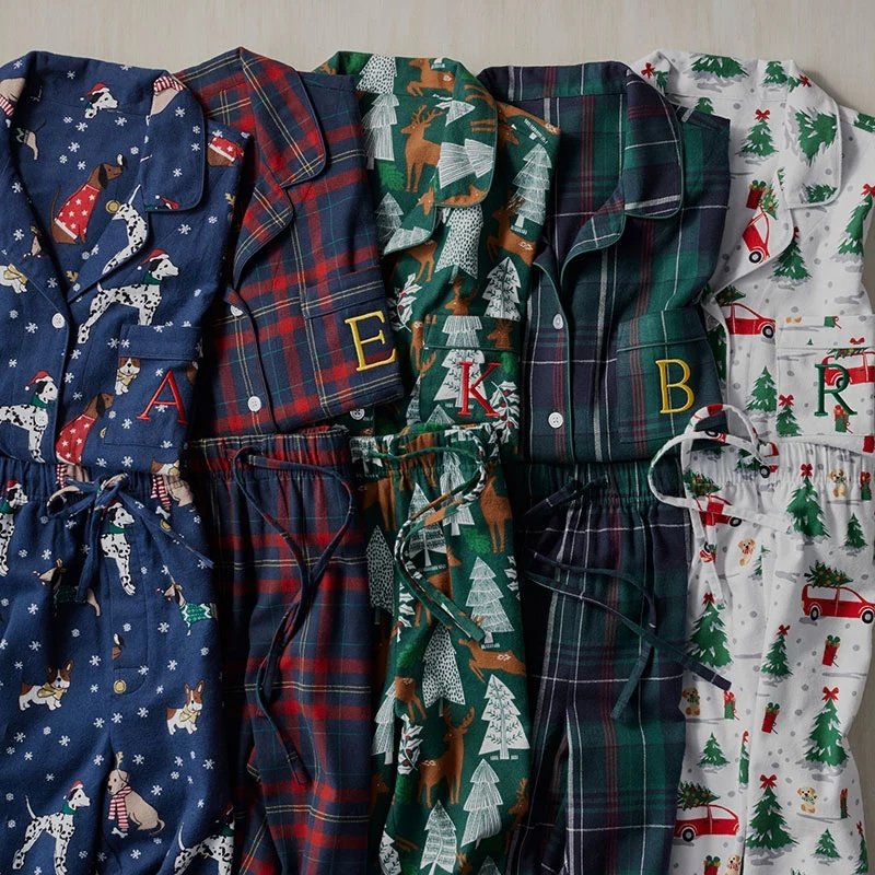 Five Company Store family Christmas pajama prints displayed side by side with monogrammed pockets